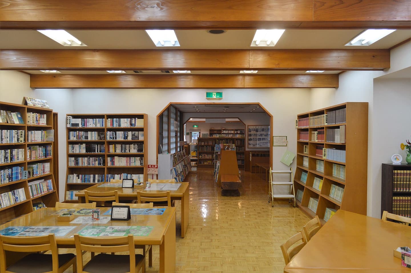 A library reading room lined with shelves of books