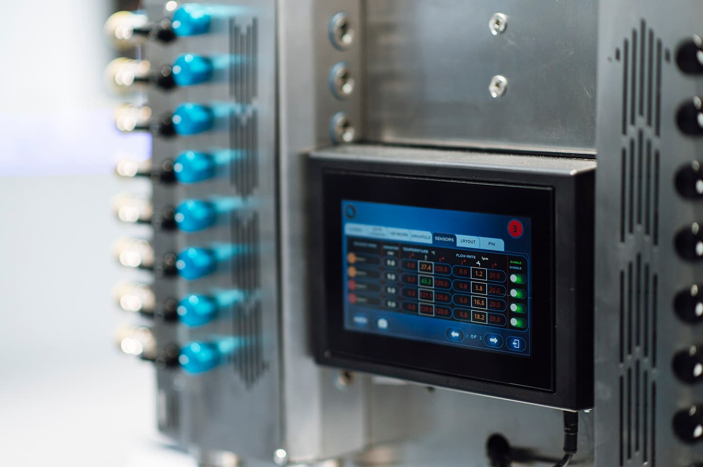 A touchscreen control panel showing sensor readings on industrial equipment