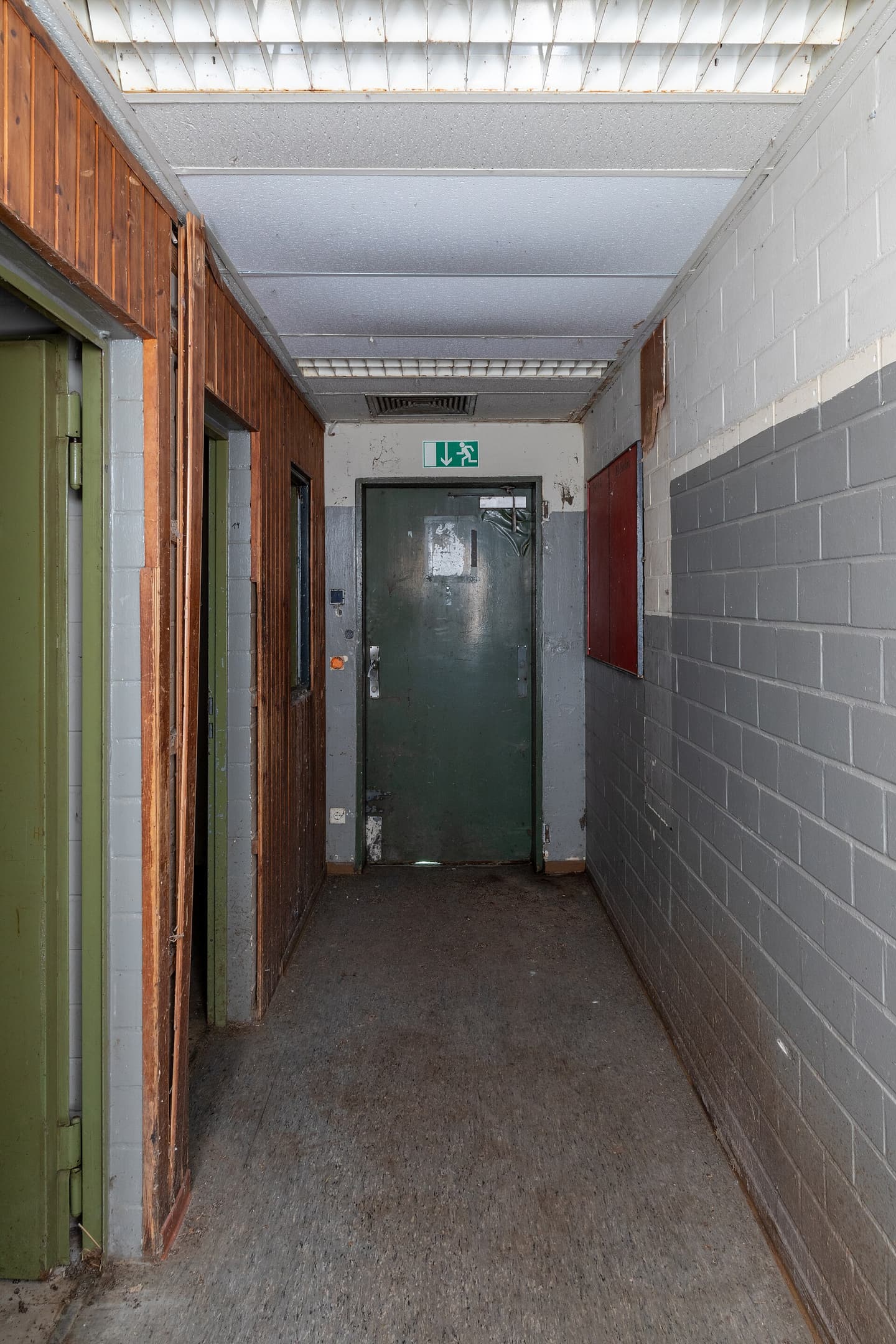 A corridor and a closed door inside a decommissioned facility